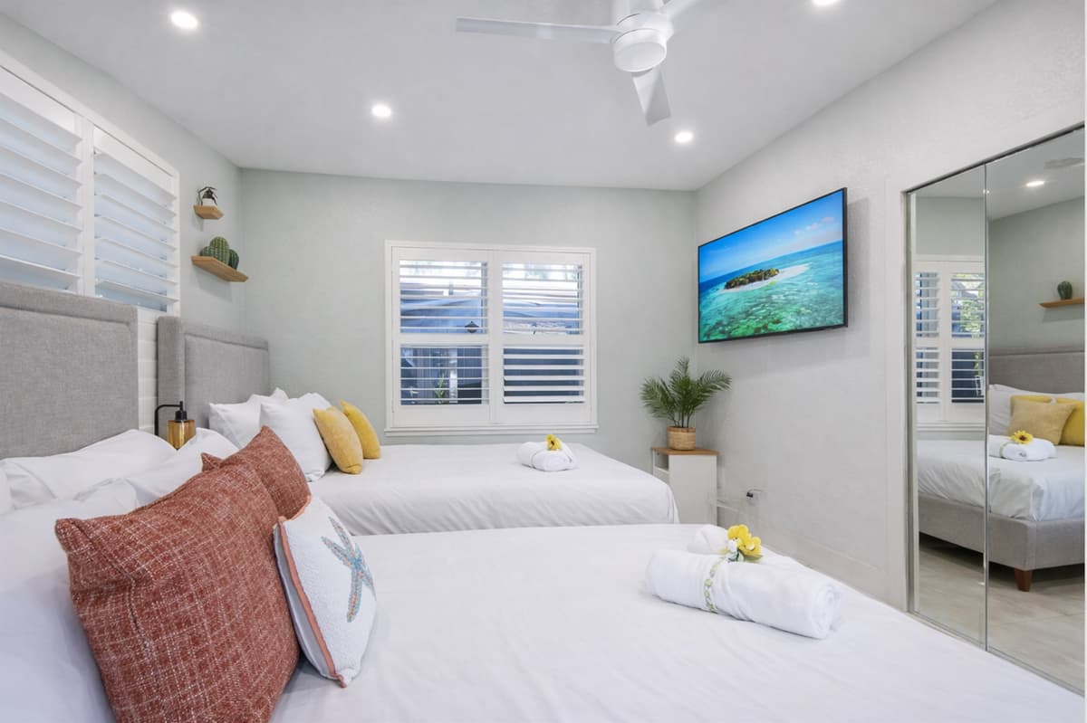 Two queen beds and straight out to the backyard — comfort meets fresh air 🌿- equipped w/ a Smart TV